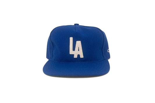 Blue cap with 'LA' logo on a white background