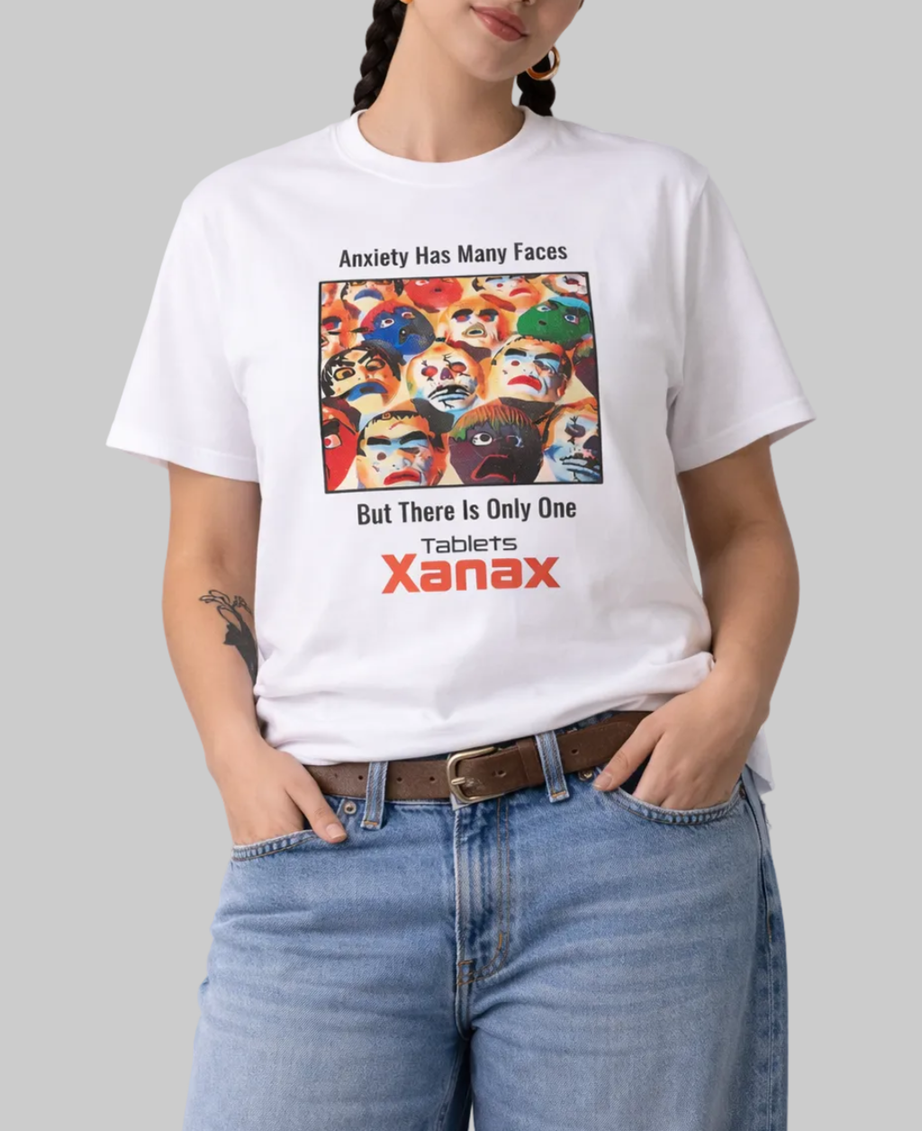 Person wearing a white t-shirt with a colorful graphic and text, standing against a plain background