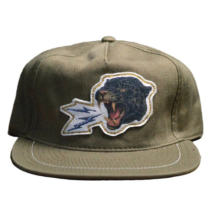 Green cap with a panther logo on a wooden surface