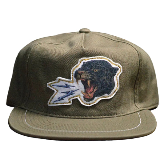 Green cap with a panther logo on a wooden surface