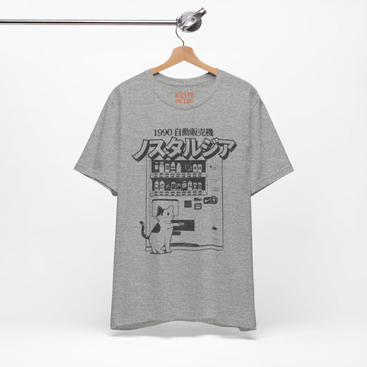 Gray t-shirt with a graphic design of a cat and vending machine on a hanger against a white background