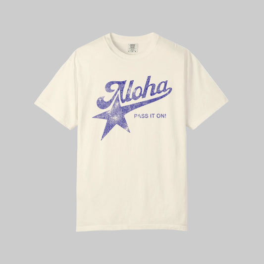Beige t-shirt with blue 'Aloha Pass It On!' graphic on a white background