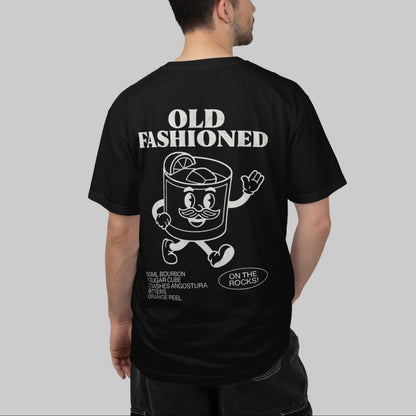 Man wearing a black t-shirt with 'Old Fashioned' graphic on the back, standing against a gray background