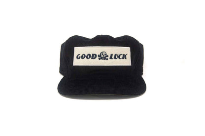 Black cap with 'Good Luck' label on a white background