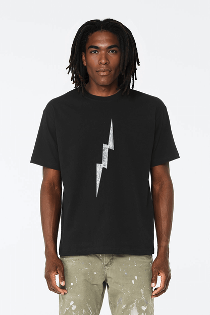 Model wearing distressed lightning bolt t-shirt in black with centered worn bolt graphic, relaxed classic fit cotton tee