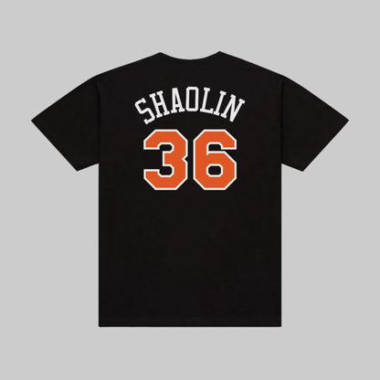 Black short-sleeve T-shirt shown from the back with 'SHAOLIN' in white varsity-style letters and the number '36' in orange with a white outline.