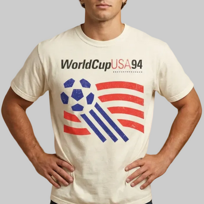 Man wearing a 'World Cup USA 94' t-shirt on a beige background
