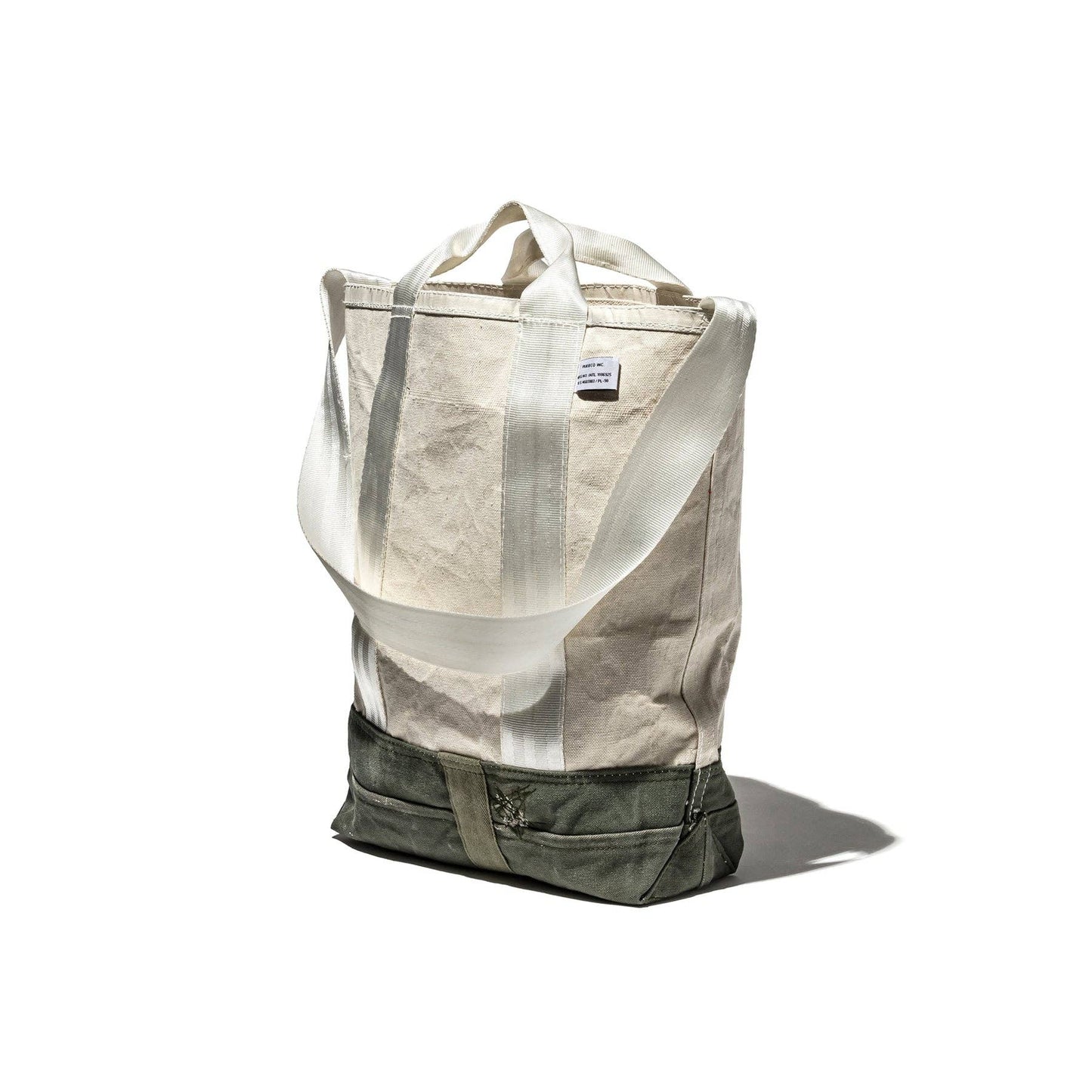 Canvas tote bag with a visible brand label on a white background