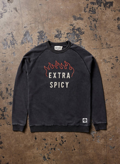 Black sweatshirt with 'Extra Spicy' text on a textured brown background