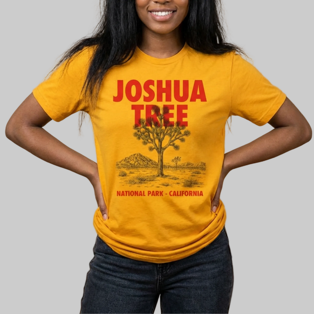 Person wearing a yellow 'Joshua Tree National Park, California' t-shirt against a beige background