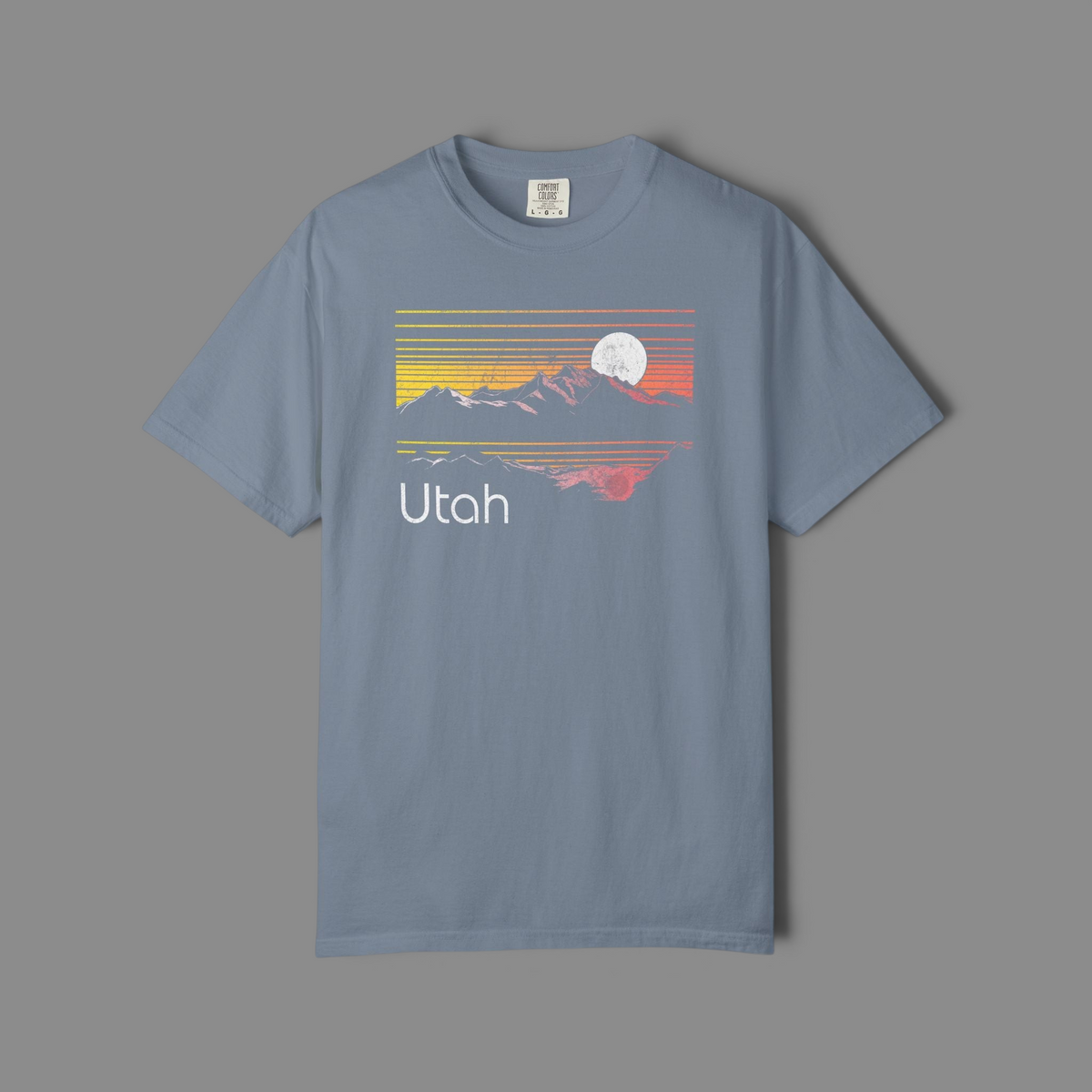 KILLER RETRO blue garment-dyed cotton t-shirt featuring a vintage Utah mountain sunset graphic with a moon.